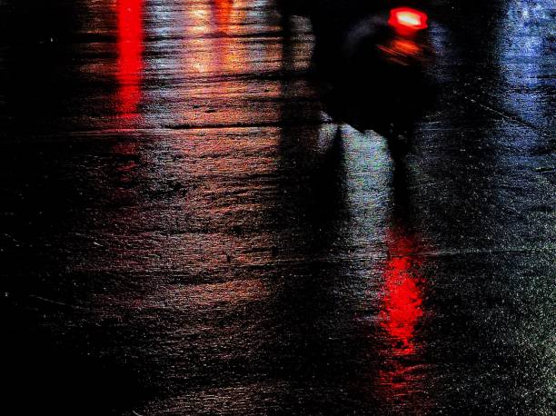 istock Defocused City Lights Reflected In Wet Street At Night 2109455768