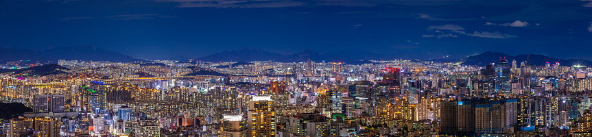 Aerial panoramic view across the crowded cityscape and futuristic skyline of central Osaka, from the skyscrapers of Umeda to the towers of Namba. ProPhoto RGB profile for maximum color fidelity and gamut.