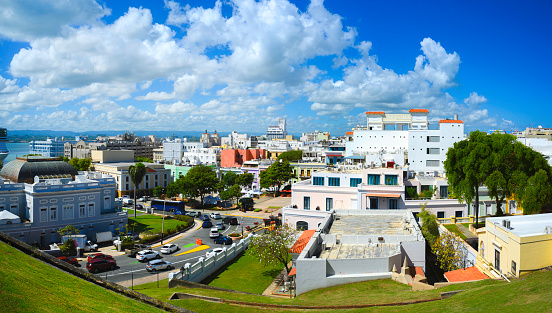 Fortín de San Gerónimo de Boquerón is a small fort located at the mouth of the Condado Lagoon, across from the historic sector of Miramar in San Juan, Puerto Rico.  This is a view from an elevated angle.  You can see the ocean and the skyline of San Juan in the background.  There are palm and other tropical trees in the foreground.