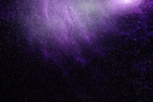 Black dark purple orange golden brown shiny glitter abstract background with space. Twinkling glow stars effect. Like outer space, night sky, universe. Rusty, rough surface, grain.