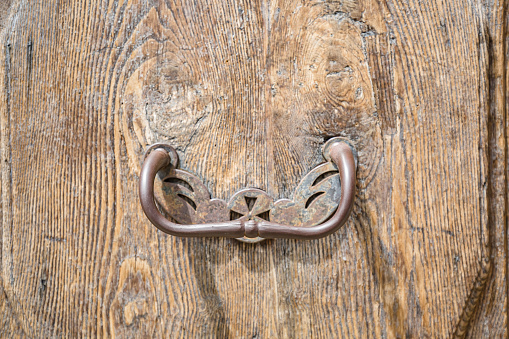 close up view of original vintage metal door knob on the wooden door