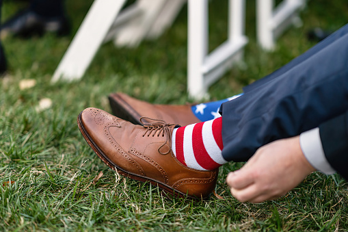 A patriotic American man wearing a pair of stars and stripes socks - electoral campaign concept