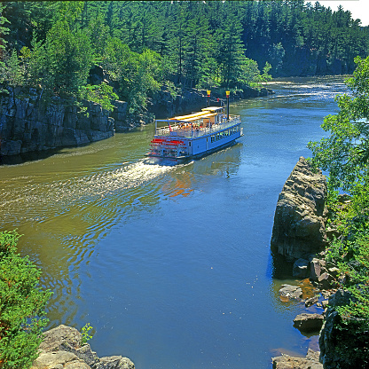 Riverboat on the St. Croix River in Minnesota, USA - a paddle steamer on a river in a gorge between rocks