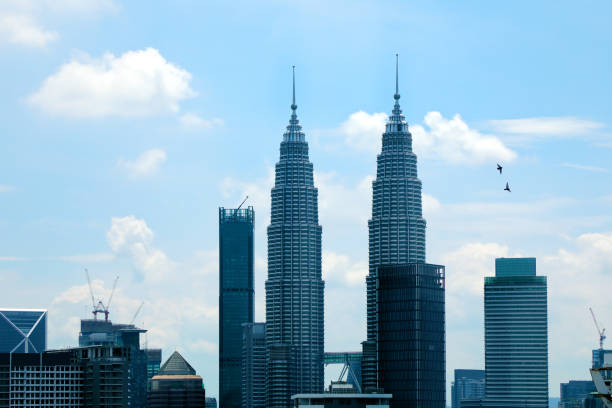 Kuala Lumpur City Centre, Kuala Lumpur, Malaysia - 12 May 2025: Kuala Lumpur skyline scenes with the iconic Petronas Twin Towers, sleek high-rises, and city gardens; dramatic clouds and evening light frame the modern urban panorama.