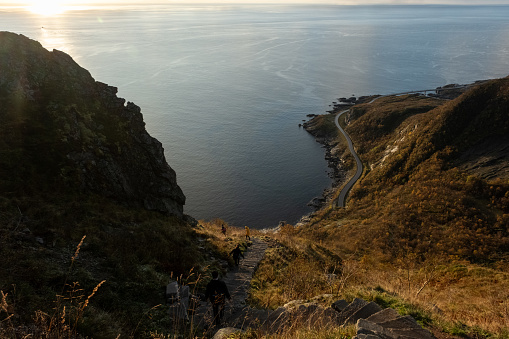 Views from top of Reinebringen mountain hike in Lofoten, Norway.  Snow covered mountains captured on image by Sony mirrorless camera.  Located far North in the Arctic Circle.  A famous hike of the Lofoten Islands.  Beautiful views at sunrise / sunset.