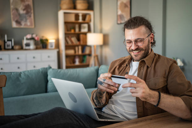 istock Handsome man shopping online or checking bank account using laptop 2109643117