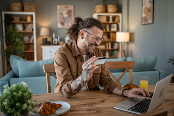 istock Handsome man shopping online or checking bank account using laptop 2109643880