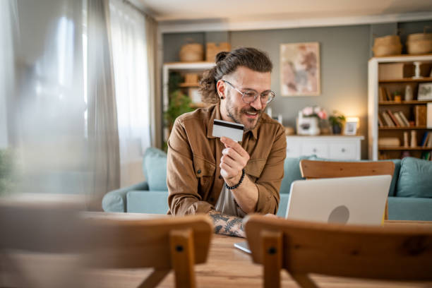 istock Handsome man shopping online or checking bank account using laptop 2109644691