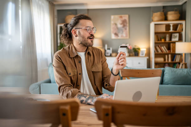 istock Handsome man shopping online or checking bank account using laptop 2109644695
