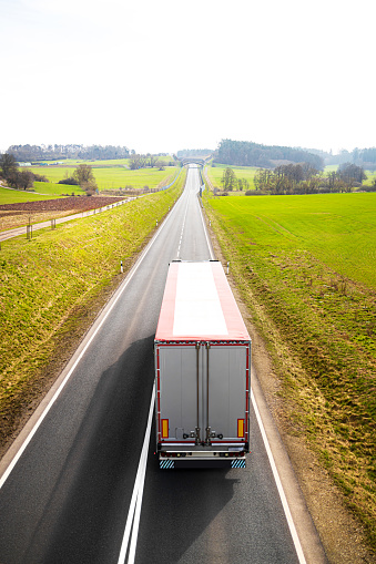 a plain truck on a country road perpendicular