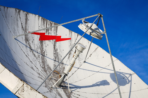 Closeup of telecommunation satellite dish pointing into the sky