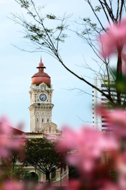 Kuala Lumpur cityscape with old clock tower,Cityscape of Kuala Lumpur Downtown in Malaysia.The Sultan Abdul Samad building in Kuala Lumpur. The Sultan Abdul Samad building has long been a famous landmark for Malaysia and Kuala Lumpur. Designed by British architect A.C Norman, it was built in 1897 with a unique Moorish-style design, Kuala Lumpur Downtown in Malaysia