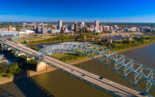 Memphis Skyline Aerial With Bridge And River Downtown Memphis skyline aerial view with the Hernando De Soto bridge and the Mississippi River and Mud Island in the foreground. hernando de soto bridge stock pictures, royalty-free photos & images