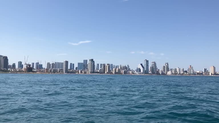 Panorama of Tel Aviv. View of skyscrapers from the sea. Modern Mediterranean metropolis. Tall houses, beach