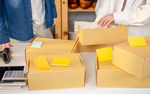 Banner of merchandiser packing itemts to boxes for delivery to customers at home or warehouse. E commerce, small own business, Retail shop Concept