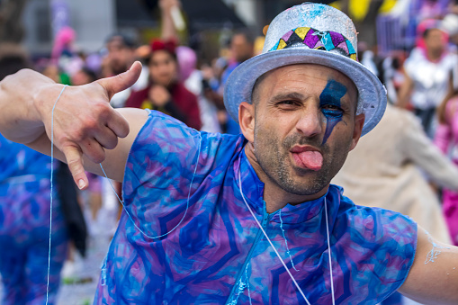 Limassol, Cyprus, March 17th, 2024: Portrait of naughty man in blue costume having fun at Grand Carnival Parade