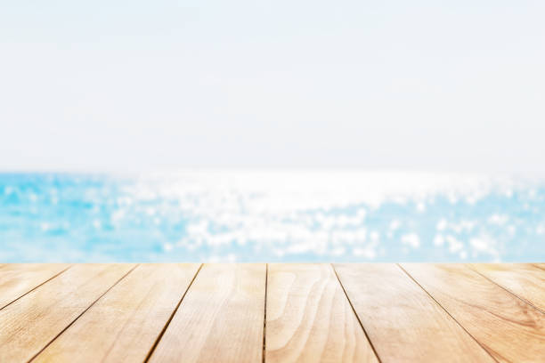 istock Old wooden table with turquoise water and blue sky background. Empty ready for your product display montage. 2109825331