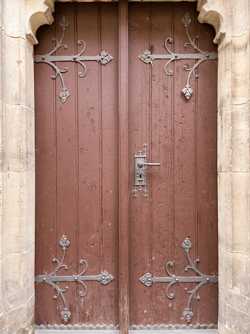 Wooden door with forged metal pattern. One of the entrances to St. Procopius Church in Prague.