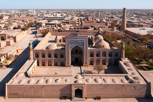 Itchan Kala Khiva City Uzbekistan Drone View over old town of Khiva - Xiva - Хива along the Silk Road with majestic Itchan Kala, Mohammed Rakhim Khan Madrassah Islamic School Complex and the Islam Khoja Minaret in the background of the City View. Itchan Kala, Khiva - Chiva, Xorazm Region, Uzbekistan, Central Asia