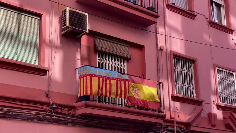 Valencian and Spanish flags hanging over balcony