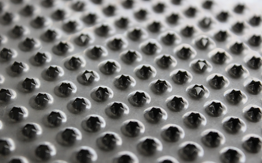 Jagged Edges Of Holes On  Shiny Metal Puree Grater