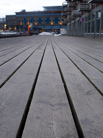 Boardwalk by the sea, wooden plank, decking, walkway, path or terrace, low angle view vertical image of patio deck pier, copy space