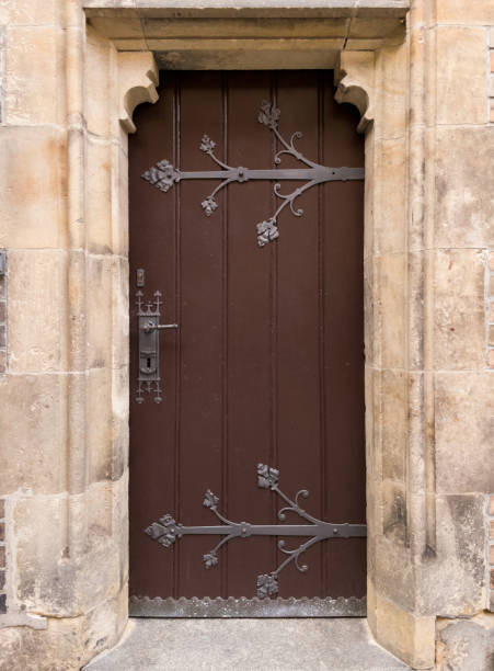 Wooden door with forged metal pattern. One of the entrances to St. Procopius Church in Prague.