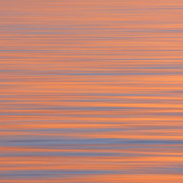 istock Motion blur of smooth calm sea reflecting a dramatic pastel sky at dusk 2109955017