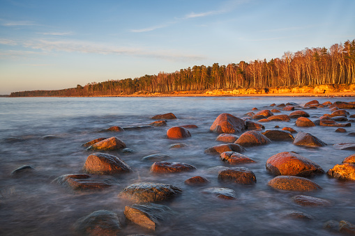 A long exposure shot of the beach rocks of Vidzeme rocky beach on a springtime sunset