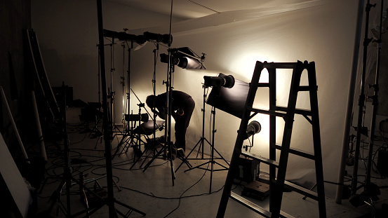 Lighting setup in studio for commercial works such as photo movie or video film production which use many LED light more than 1000 watts with big softbox snoot reflector umbrella and tripods.