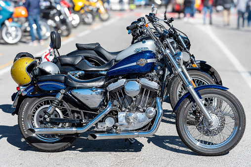 Italy - March 24, 2024: Harley Davidson motorcycle with V Twin engine with customlized tank colors, Harley-Davidson Motor Company is historic U.S. motorcycle manufacturer.