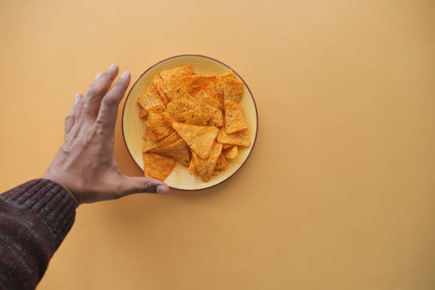 istock top view of men hand pick potato chips 2110040661