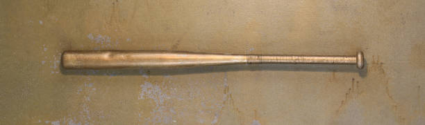 istock golden baseball bat on old background 2110060716