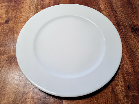 Empty White Plate on Wooden background