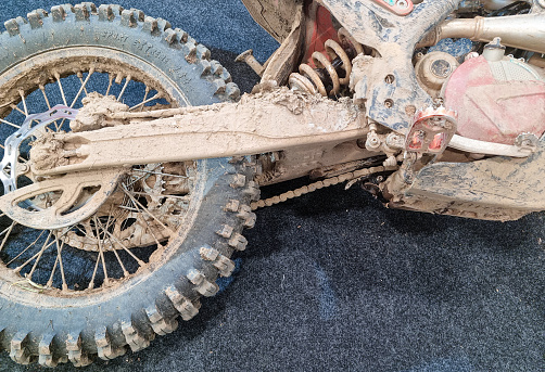 View of a dirtbike on the dirt road up to hill.