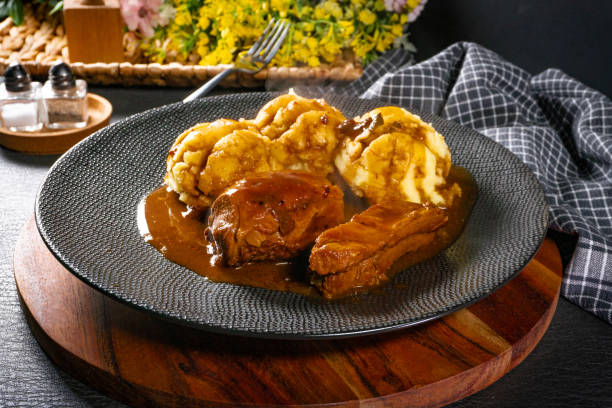 istock Traditional German braised pork cheeks in brown sauce. 2110099225
