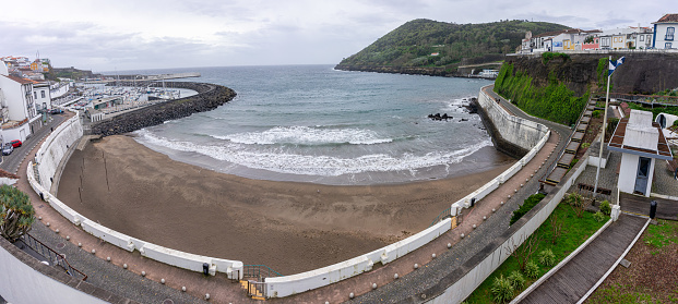 Angra do Heroísmo, Azores, Portugal. March 11, 2024. Prainha beach in Angra do Heroísmo, with Monte Brasil in the background. Idyllic coastal scenery in the Azores.