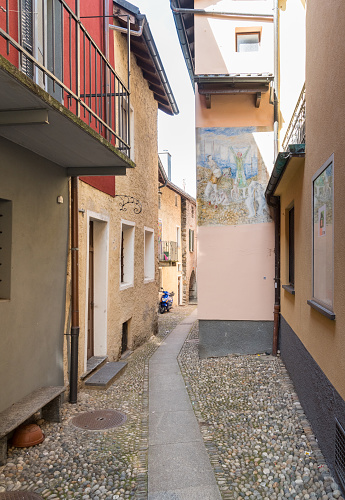 Vira Gambarogno, Ticino, Switzerland - March 21, 2024: Narrow street in the historic center of Vira Gambarogno, the town overlooks Lake Maggiore, district of Locarno.