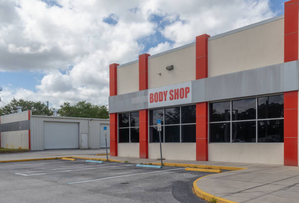istock Wide angle body shop building with empty parking spaces in front 2110114738
