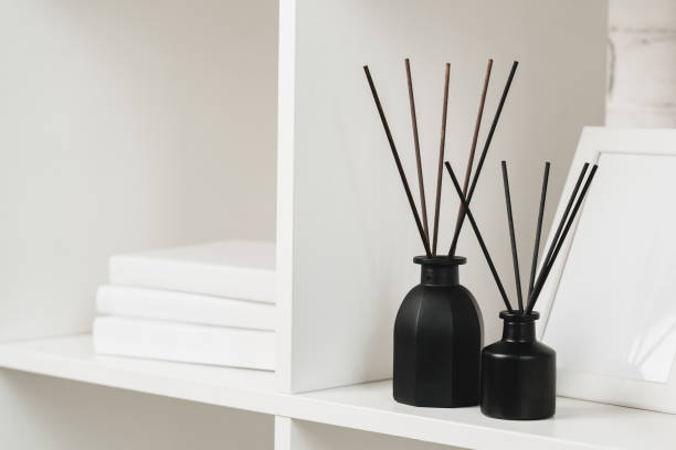 istock Elegant Black Reed Diffuser on White Shelf in Minimalist Home Decor Setting 2110129905