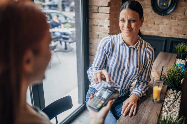 istock Woman paying with smart phone 2110134143