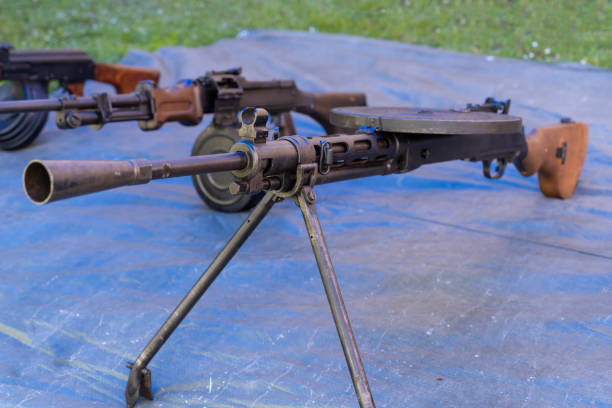 istock WW2 Soviet machine gun with round ammunition magazine on a blue tarpaulin 2110154318