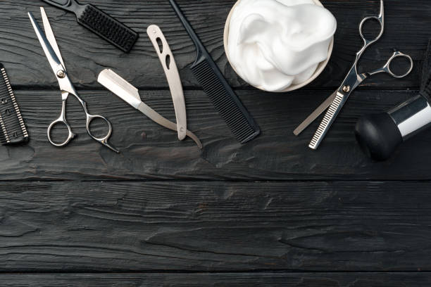 istock Professional Barber Tools Laid Out on Dark Wooden Surface 2110185543