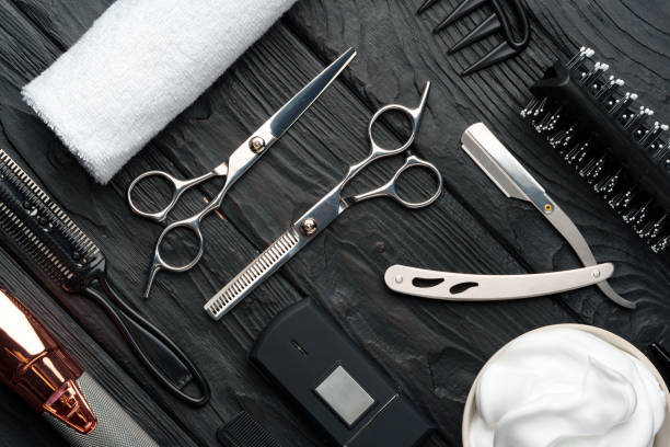 istock Professional Barber Tools Laid Out on Dark Wooden Surface 2110185547