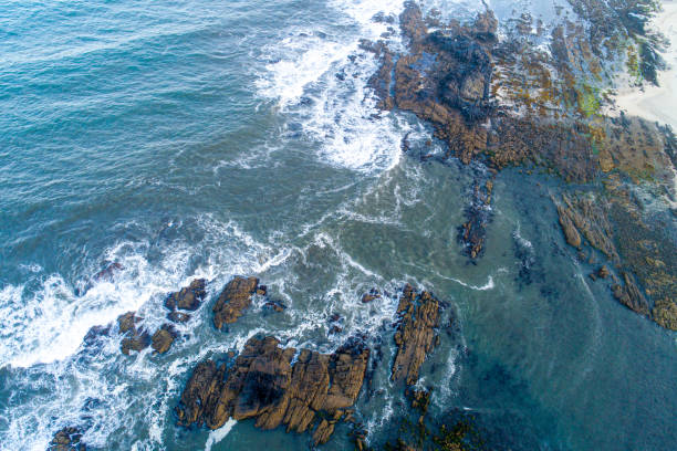 istock Foaming and splashing on rocks near the shore, drone top view 2110205567