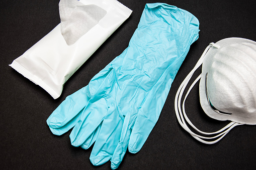 Surgical medical gloves, protective medical mask and disinfectant wipes are used by doctors during procedures performed in hospitals, but also by people infected with the covid virus. Protection concept