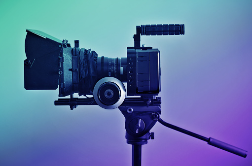 Professional type of equipment, symbol of filmaking industry and entertainment. Side view, color graded shot