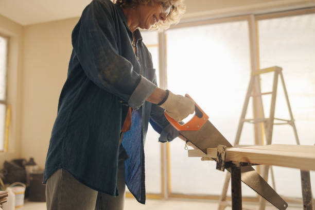 istock Renovation in the making: Skilled woman upgrades home interior with custom woodwork 2110226600
