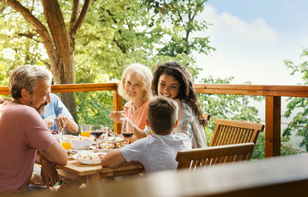istock Family having dinner at a weekend house. 2110232341