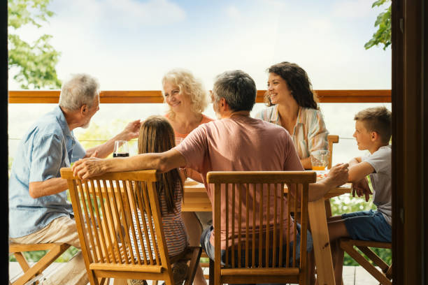 istock Family having dinner at a weekend house. 2110232342